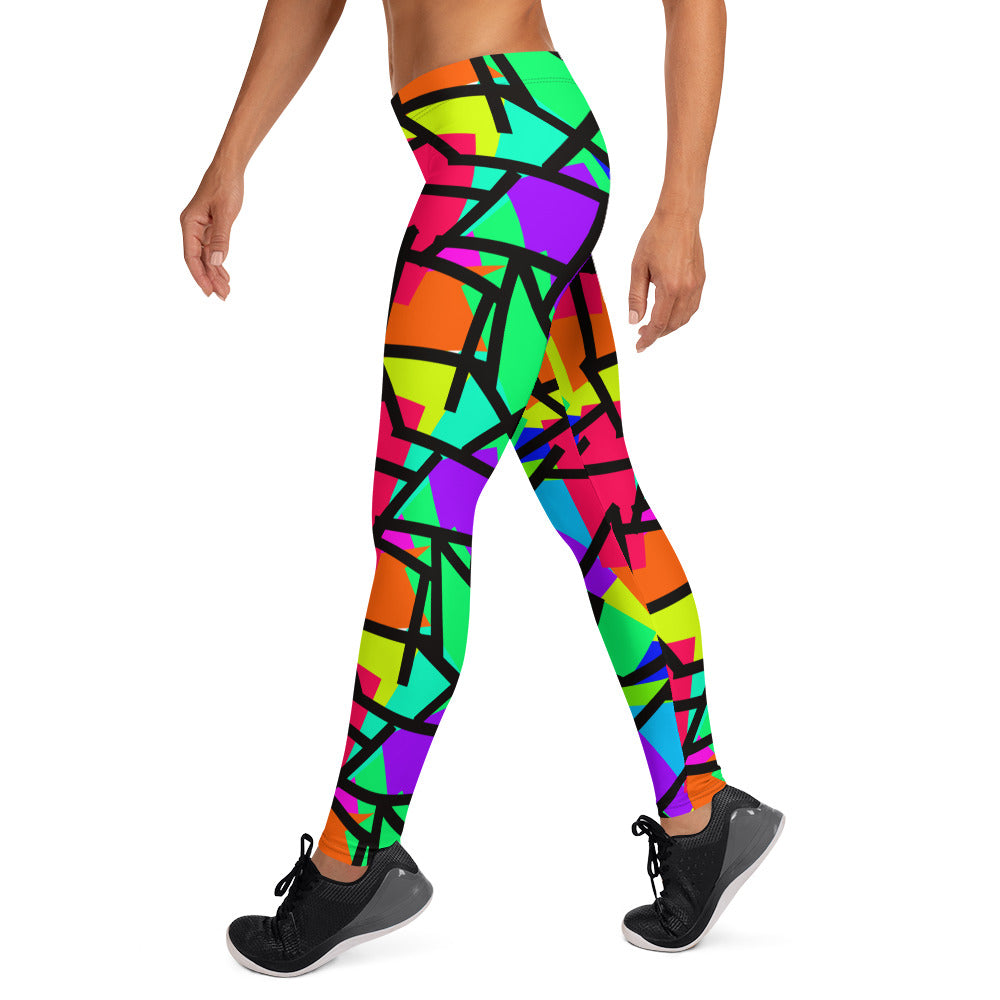 Harajuku Yume Kawaii fashion meggings or womens leggings in brightly coloured Pop Kei 80s Memphis design in red, orange, green, purple, yellow and turquoise geometric shapes and a black zigzag overlay on these neon funky running tights for women.