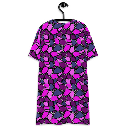  geometric patterned t-shirt dress in a vibrant futuristic Synthwave colour palette against a black and white dotted background. Available here in a metallic purple style.