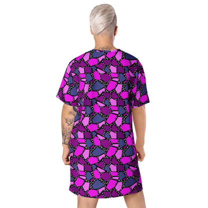  geometric patterned t-shirt dress in a vibrant futuristic Synthwave colour palette against a black and white dotted background. Available here in a metallic purple style.