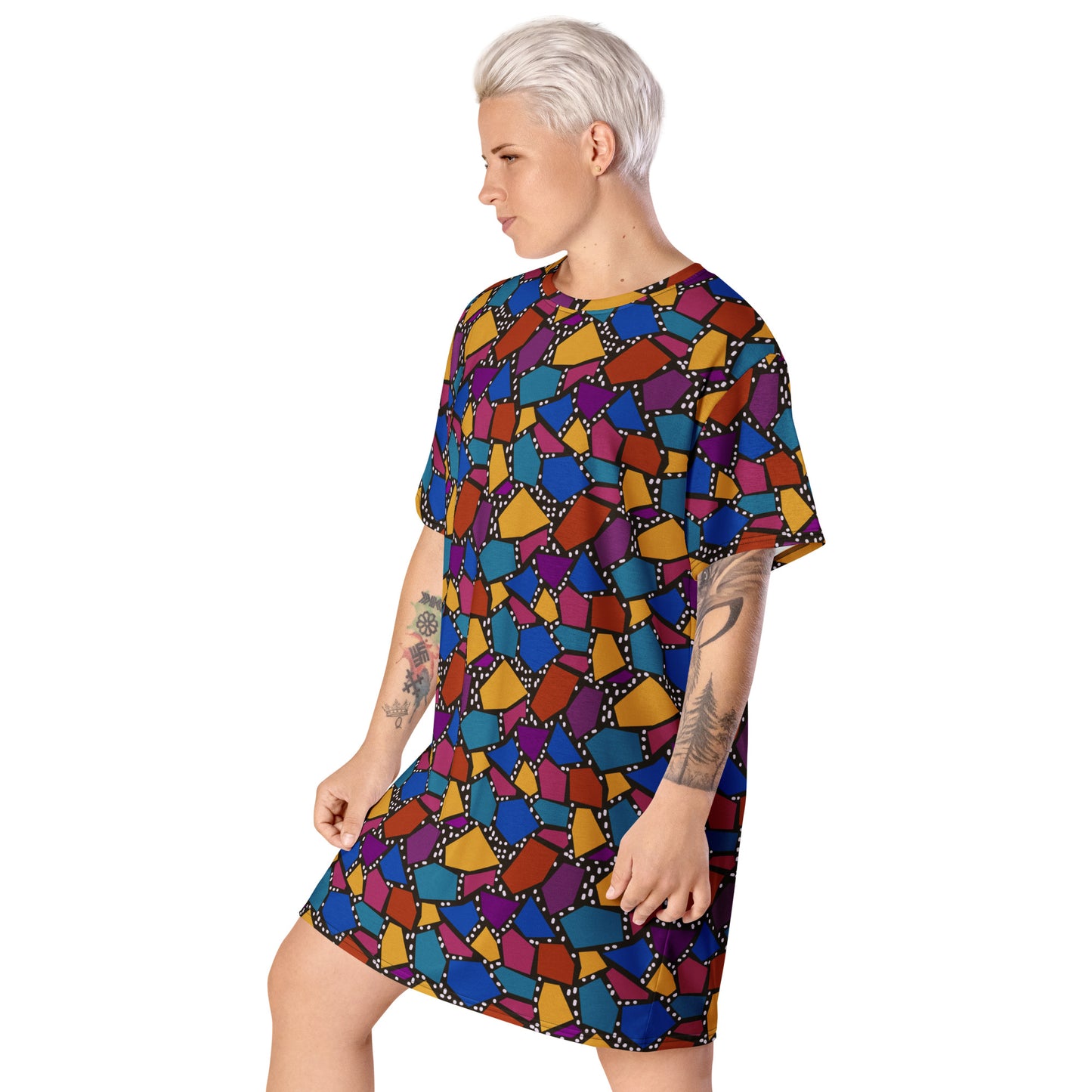 Striking geometric patterned t-shirt dress in a vibrant futuristic Synthwave colour palette against a black and white dotted background. Available here in a muted rainbow style.