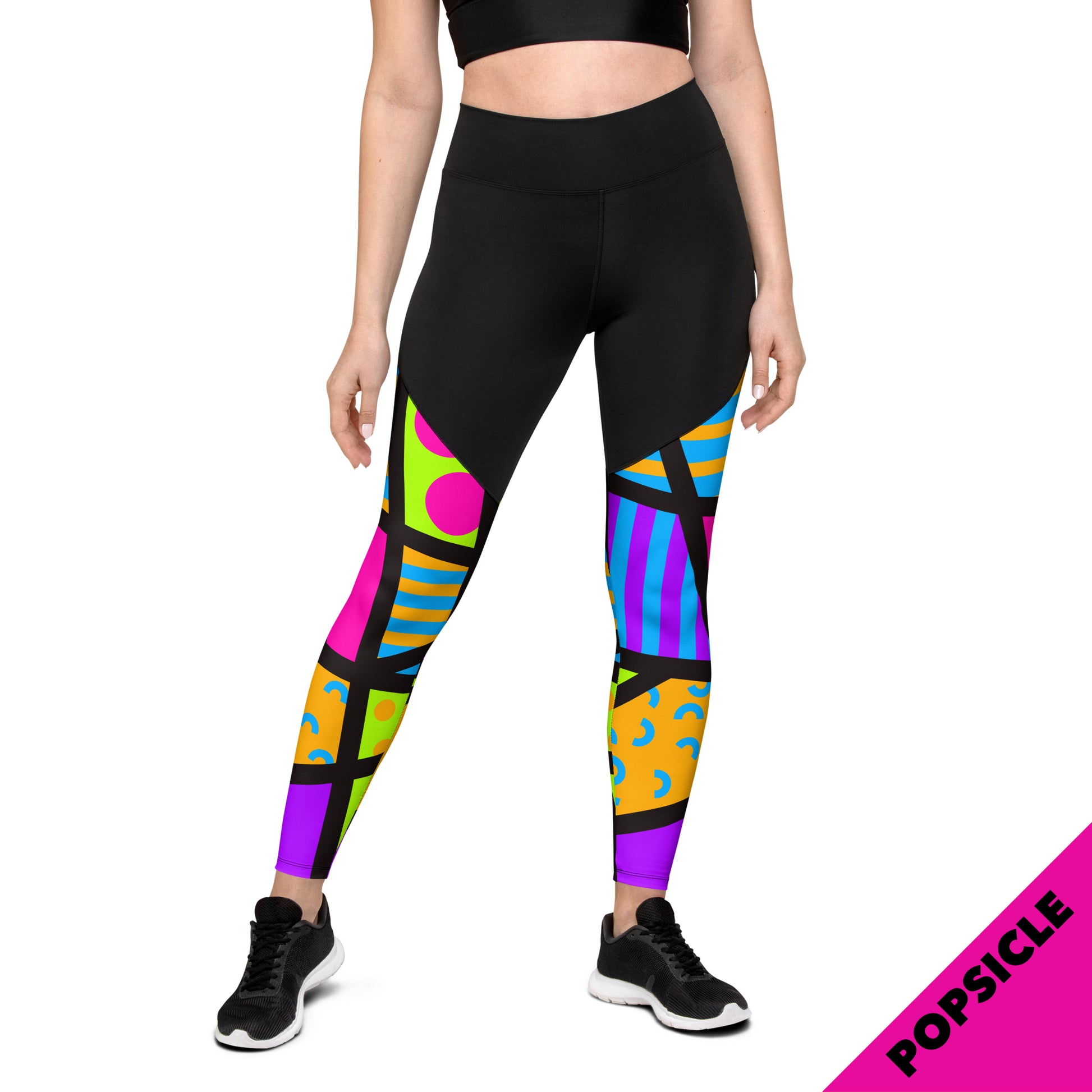 Sports leggings for women with black upper top and geometric popping pink, orange and blue patterned legs. Compression ankle length gym leggings with high elasticated waistband. Non-see through and squat proof leggings.