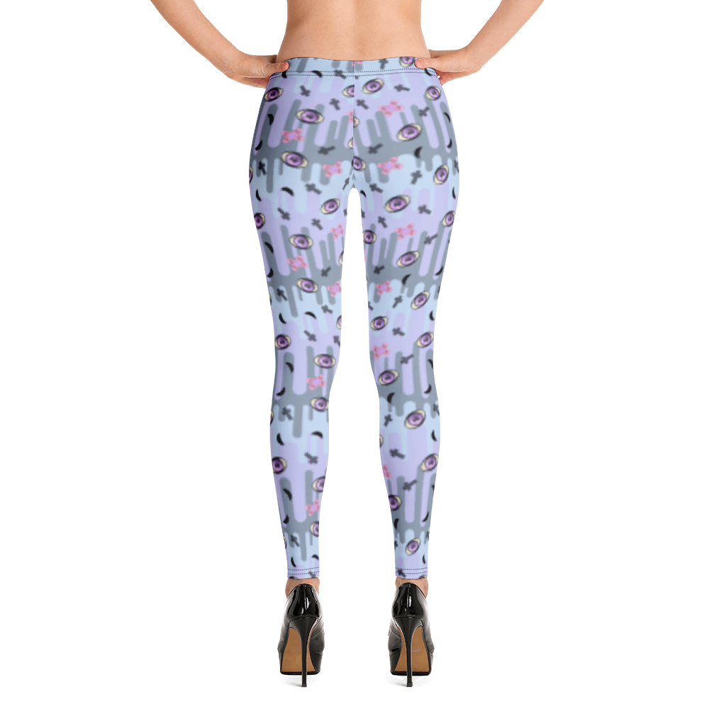 Pastel goth design harajuku leggings for women with a spooky pattern of eyeballs, crosses and black moons against a pastel drip design on these festival pants or running tights for women by BillingtonPix