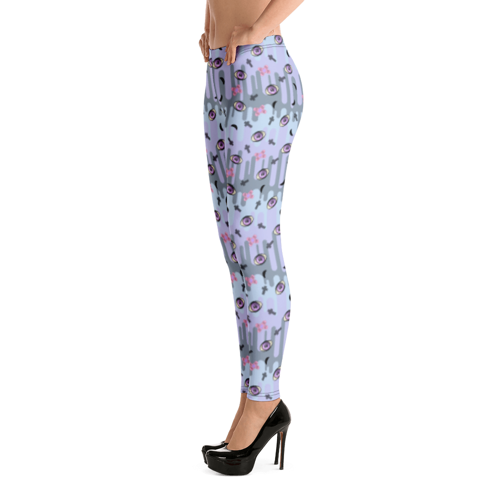 Pastel goth design harajuku leggings for women with a spooky pattern of eyeballs, crosses and black moons against a pastel drip design on these festival pants or running tights for women by BillingtonPix