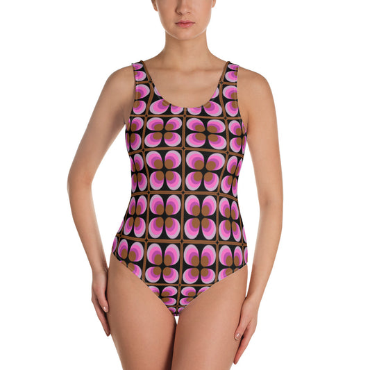 Retro vintage style patterned one piece swimsuit in pink, black, lilac and brown 70s abstract geometric floral pattern