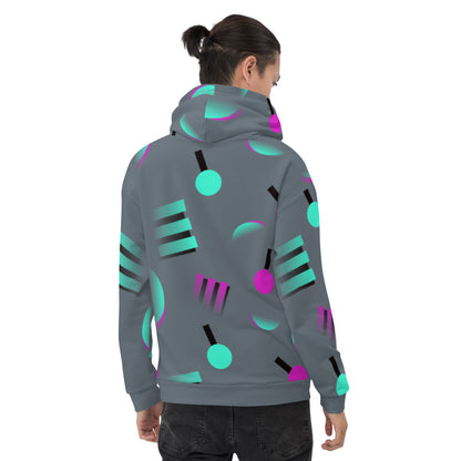 Colourful grey hoodie with an 80s Memphis and 90s Vaporwave inspired geometric pattern, consisting of large circular and square shapes in pink and mint against a blue background on this hoodie pullover by BillingtonPix