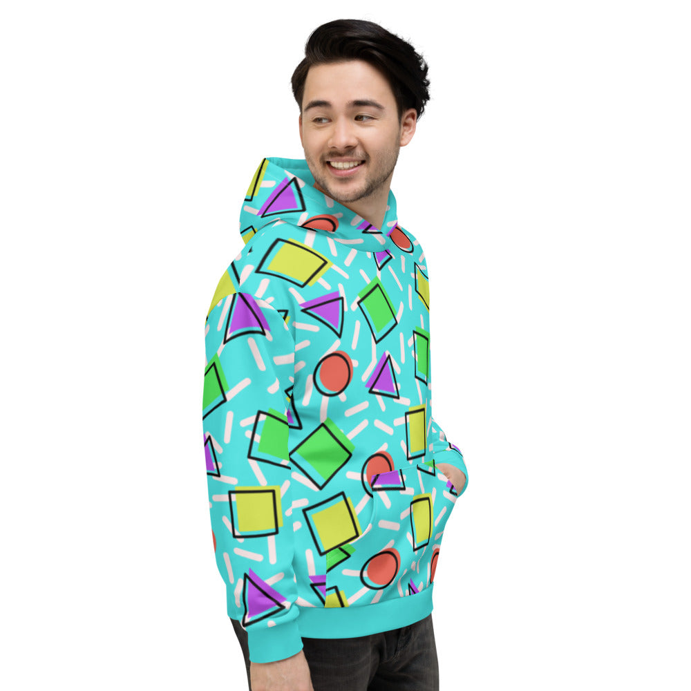 Retro style 80s Memphis design hoodie pullover with colourful rainbow primary colors in geometric shapes squares, circles. triangles with a random white pattern below all over a turquoise blue background on this best athleisure relaxed fit hoodie by BillingtonPix