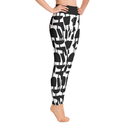 This Mid-Century Modern style black and white yoga leggings pattern consists of black irregular abstract shapes connected vertically by black strings against a white background with a high waistband and inside pocket