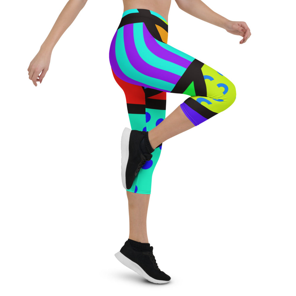 Capri leggings for women in a retro 80s Memphis design. Rainbow colored geometric all-over pattern with black overlay. Calf length legs and mid-rise elastic waistband.