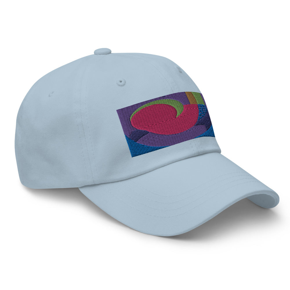 Light blue dad hat with colorful rectangular logo containing blocks of colors of pink, purple, green and blue, curves and geometric shapes in a mid-century modernist abstract composition