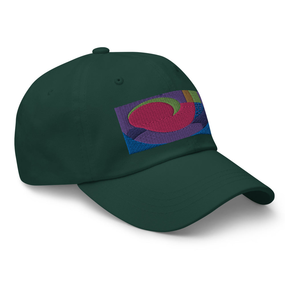 Spruce green dad hat with colorful rectangular logo containing blocks of colors of pink, purple, green and blue, curves and geometric shapes in a mid-century modernist abstract composition