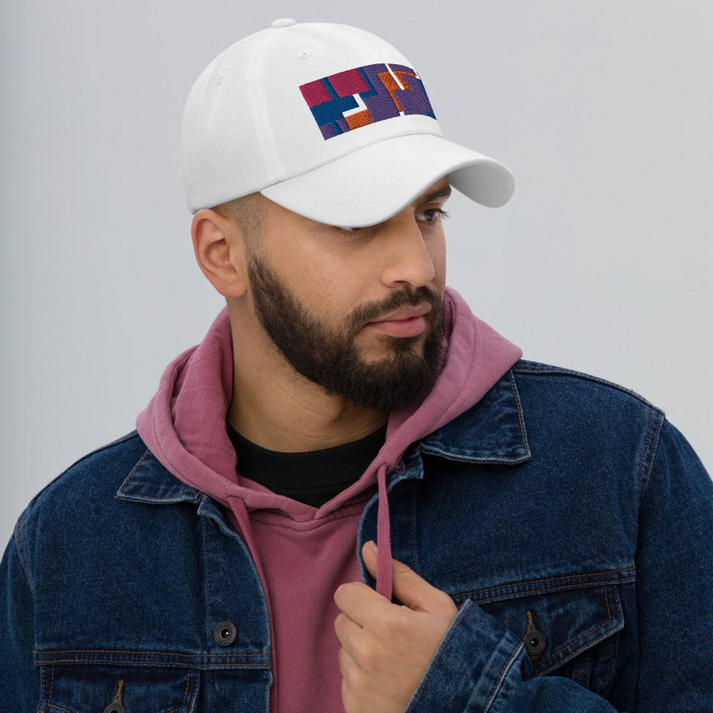 Colorful pink, orange, purple and blue geometric shapes patterned rectangular logo on this white colored dad hat