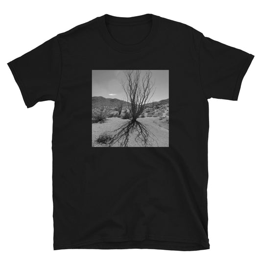 Californian desert landscape black and white photograph print t-shirt featuring a ghostly cactus plant casting a dark shadow across the desert floor in the foreground on this black cotton t-shirt by BillingtonPix