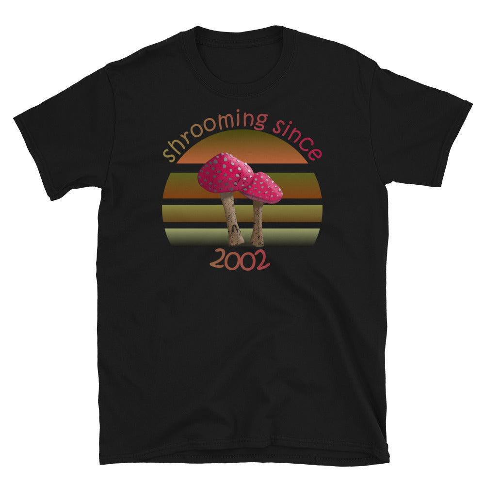 Shrooming since 2002 cute Goblincore style design with two red fly agaric mushrooms with distressed look against a multi-toned nature colour palette abstract vintage sunset design on this black cotton t-shirt by BillingtonPix