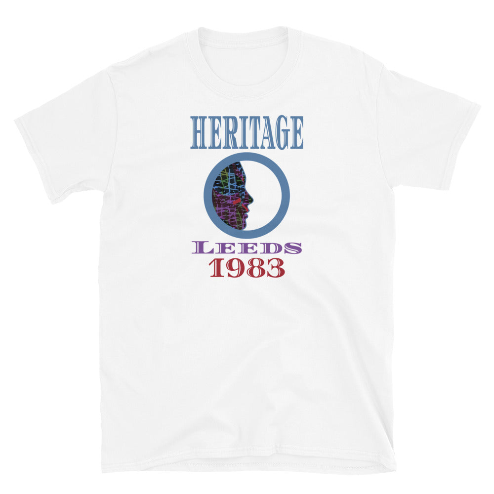 Graphic t-shirt with a patterned profile face in abstract design, tones of blue, green, purple, red, in circular format, with the words Heritage Leeds 1983 in blue, purple and red on this white cotton t-shirt by BillingtonPix